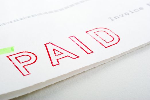 Macro of Paid stamp on invoice, shallow DOF