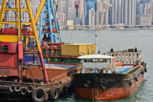 Stock photo of unloading shipping containers from a lighter in Victoria Harbour, Hong Kong.