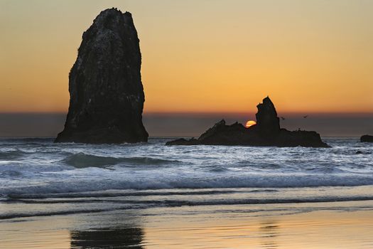 Sunset Over Haystack Needles Rock on Cannon Beach Oregon Coast with Waves and Seabirds