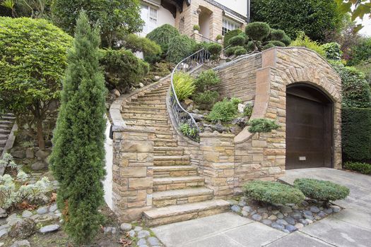Stone Veneer Faccade on Home Exterior with Manicured Front Entrance Yard Landscape