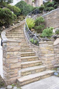 Stone Veneer Faccade on Home Exterior Staircase with Manicured Front Entrance Yard Landscape