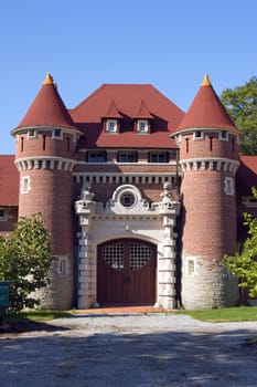 Castle towers and gate on blue sky background