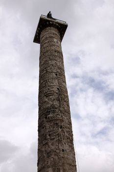 The Column of Marcus Aurelius against a cloudy sky, in Rome, Italy.  It was completed in 193 AD to honour the Roman Emporer.
