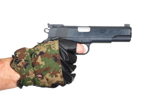 Hand in camouflage glove with gun