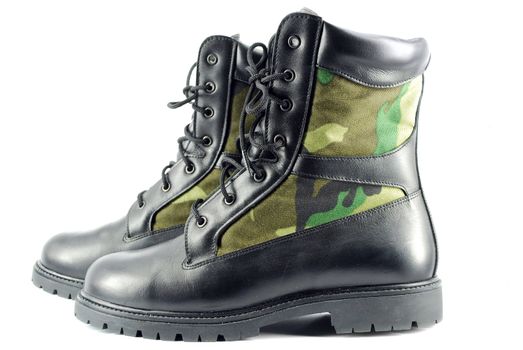 Military camouflage combat boots on white