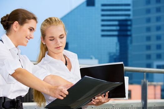 picture of two happy businesswomen with documents