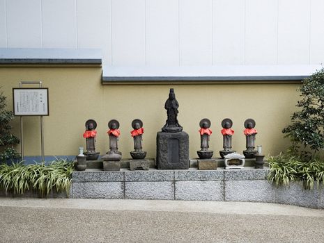 religious figures and garden in urban tokyo japan
