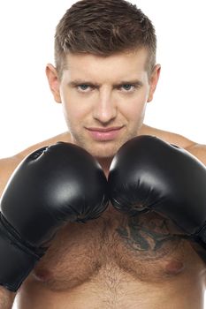 Close up picture of young caucasian boxer with tattoo on his chest