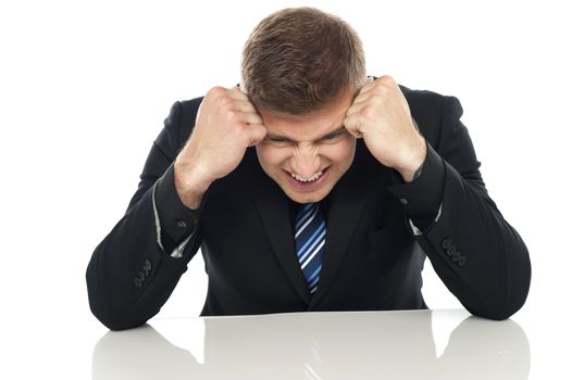 Frustrated businessman. Hands on his head
