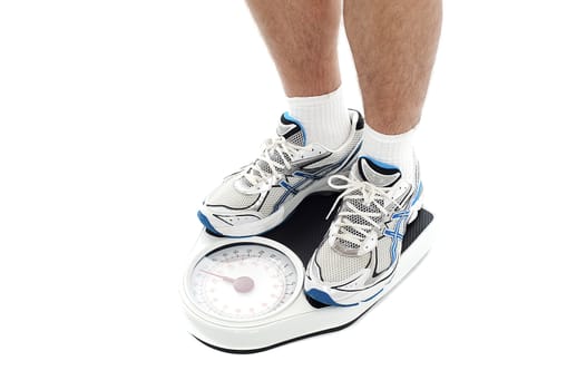 Male person standing on weighing scale. Extreme closeup. All on white background