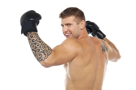 Portrait of male winner boxer turning around and looking at you