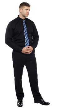 Thoughtful serious businessman. Full length portrait