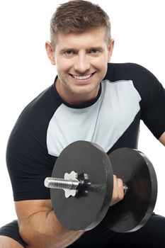 Closeup shot of masculine man doing biceps with dumbbell