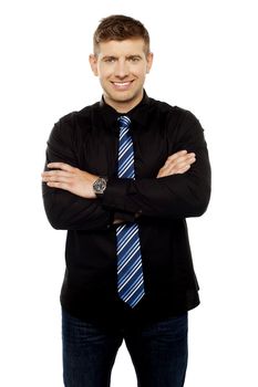 Portrait of confident handsome businessman posing with folded arms