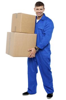Full length portrait of young smart relocation staff carrying cartons