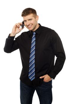 Cheerful businessperson communicating through cellphone while looking at you