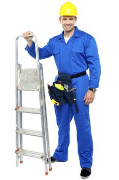 Young construction worker ready to get to work with stepladder isolated over white