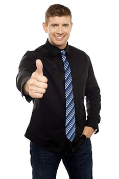 Smart young executive showing thumbs up isolated over white