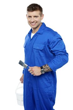 Male painter with bucket and brush isolated against white background