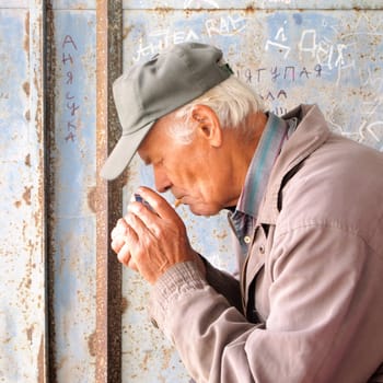 senior lights a cigarette
