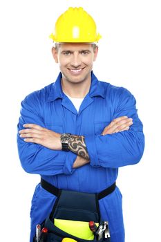Young repairman in uniform posing with crossed arms isolated over white background