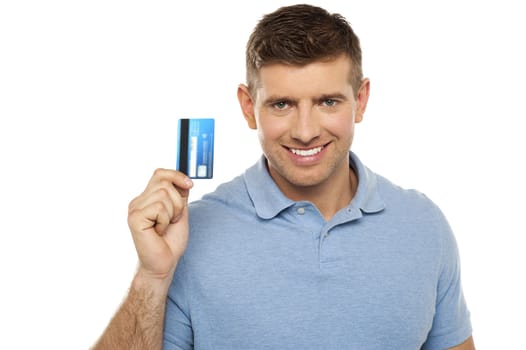 Cheerful man holding credit card. Closeup shot