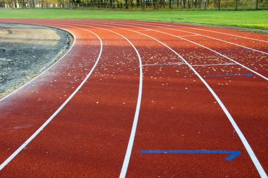 Athletics stadium running track red lines marks. Special track cover sports background.