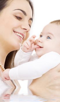 picture of happy mother with baby in water