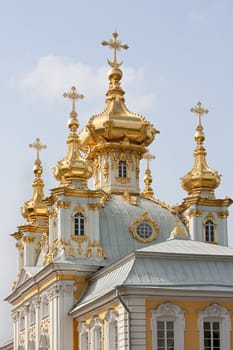 Fragment of  golden domes and church building in Peterhof, Russia.