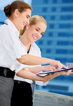 picture of two happy businesswomen with paper chart