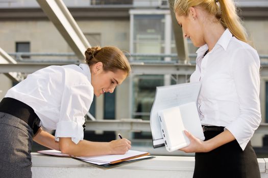 picture of two happy businesswomen with documents