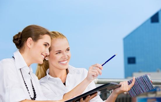 picture of two happy businesswomen (focus on blonde)