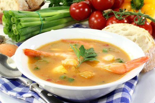 a bowl of bouillabaisse with shrimp and mussels