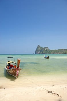 boat on tropical ko phi phi beach in thailand