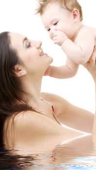 picture of happy mother with baby in water (focus on baby)