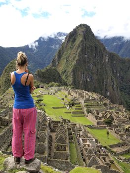 Tourist looking at the lost city of Machu Picchu, Peru
