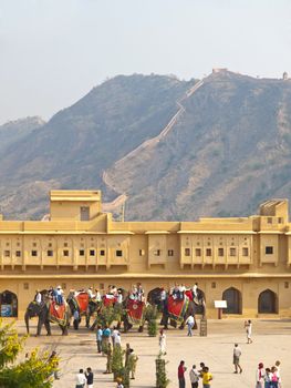 AMBER, INDIA - 7 NOVEMBER, 2009: Indian elephant riders wait for tourists behind the wall of Amber Fort on November 7, 2009. 