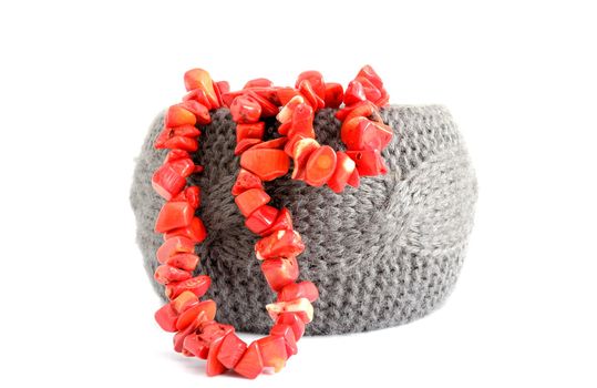 crocheted gray bracelet and red coral beads over white