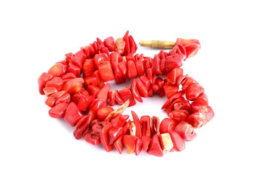 red coral beads over white background