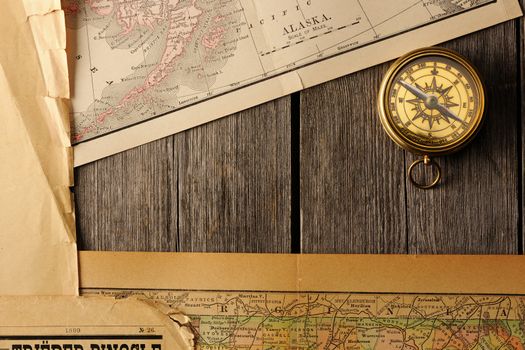 Antique brass compass over old map