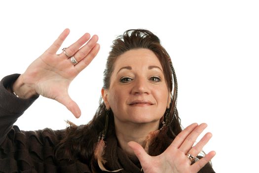 Creative woman with vision frames a scene with her hands isolated over a white background.