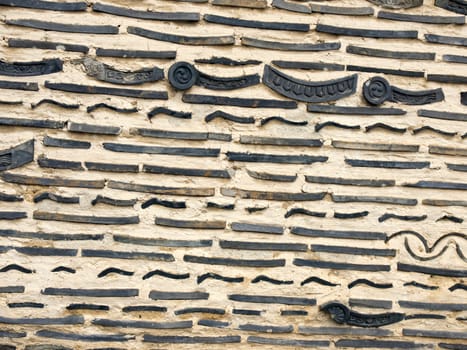 Old brick and Japanese roof tile in the wall