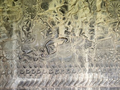 Stone carvings of the army bas relief on the corridor of Angkor Wat Temple in Siem Reap, Cambodia.