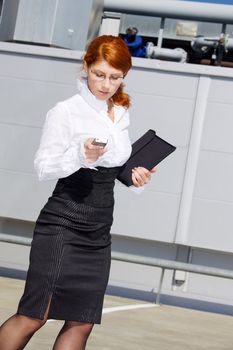 bright picture of businesswoman with folder and phone