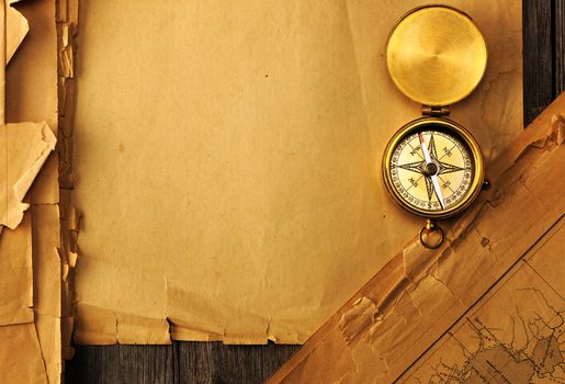 Antique brass compass over old map