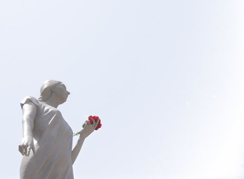 Sculpture of santa rosalia with red rose in hand isolated on white background. Palermo, Sicily