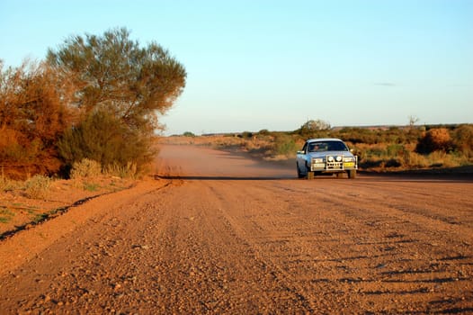 Car at the gravel road, red dirt, Western Australia