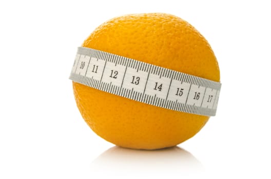 Orange fruit wrapped with measuring tape. Isolated over white background. Concept of fighting off cellulite.