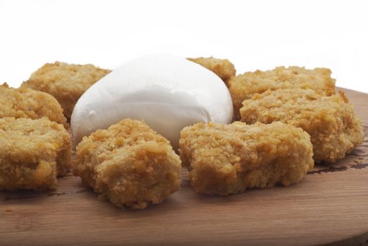 fried chicken nuggets and mozzarella cheese on wooden desk