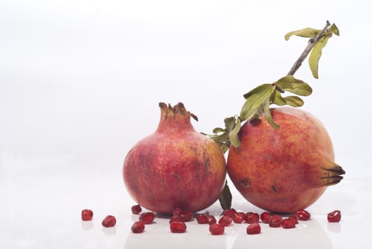 pomegranates with leaves on a white background
